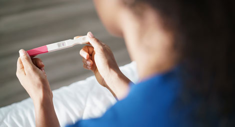 Woman looking at a pregnancy test