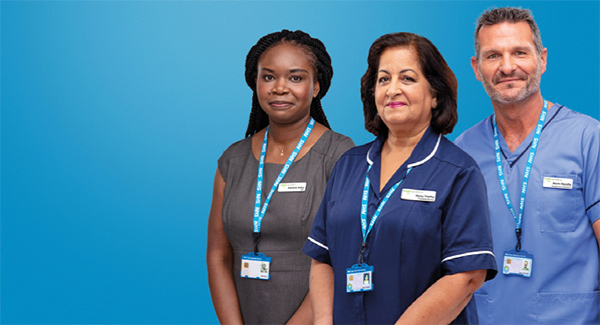 Two ladies and man wearing NHS uniforms